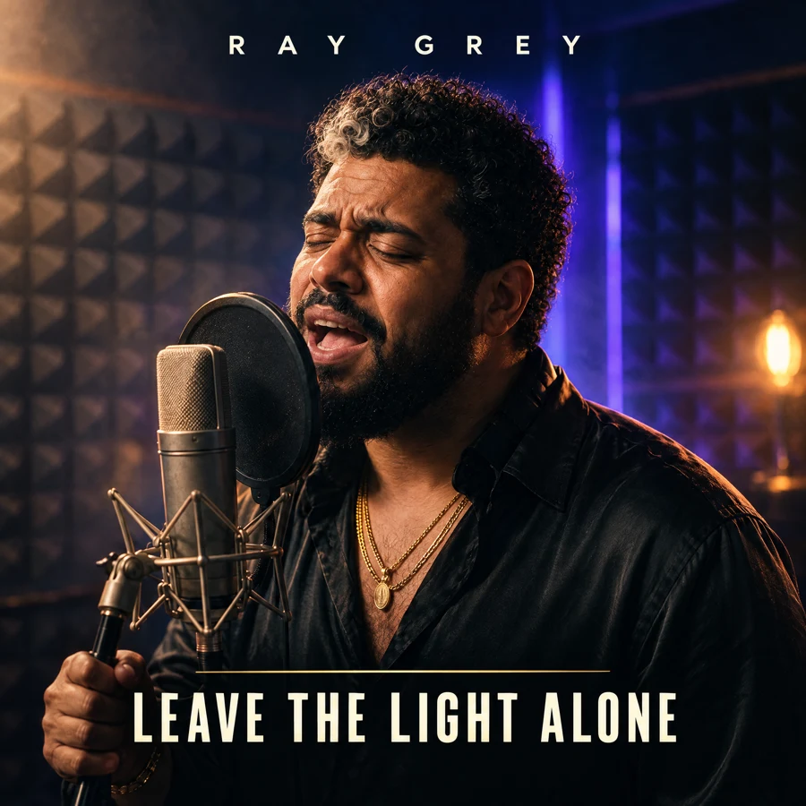 Leave the Light Alone artwork: Ray Grey singing into a studio microphone under warm amber light.